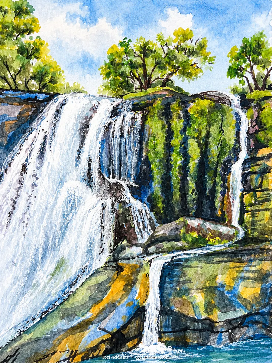 A painted cascade tumbling across mossy rocks