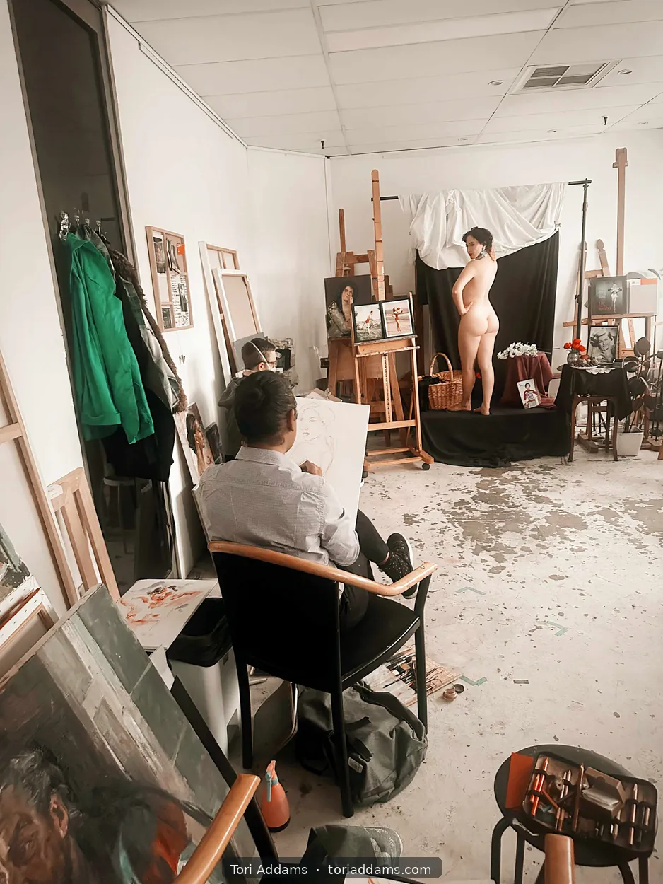 An artist draws Tori during a studio life-modelling session