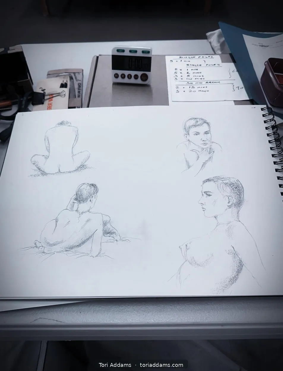 Several timed gesture drawings in an artist's sketchbook